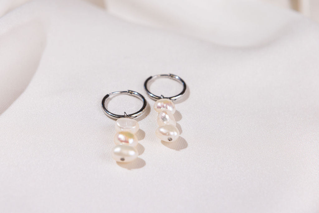 Pair of pearl earrings on a white background