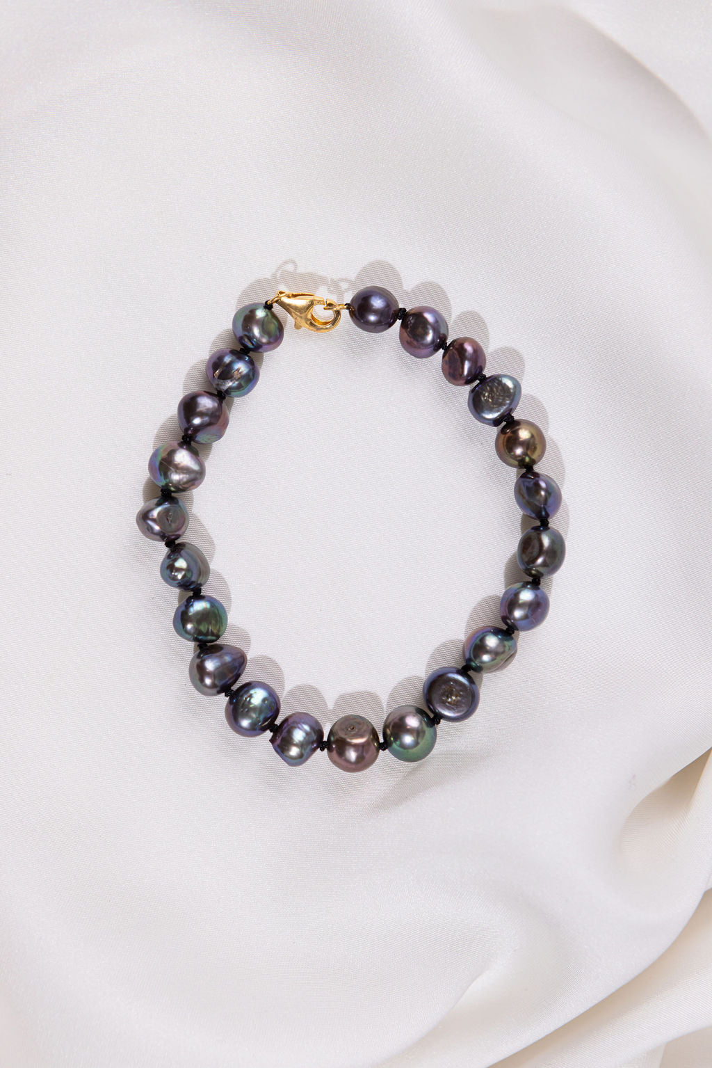 Black Pearl bracelet with a gold clasp on a white background
