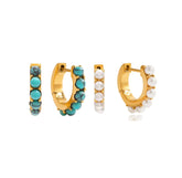Two pairs of gold hoop earrings with turquoise and pearl stones on a white background