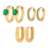 Set of gold hoop earrings with green gemstones on a white background
