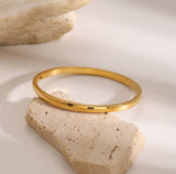 Gold bracelet on a natural stone surface