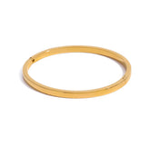 Gold bangle on a white background