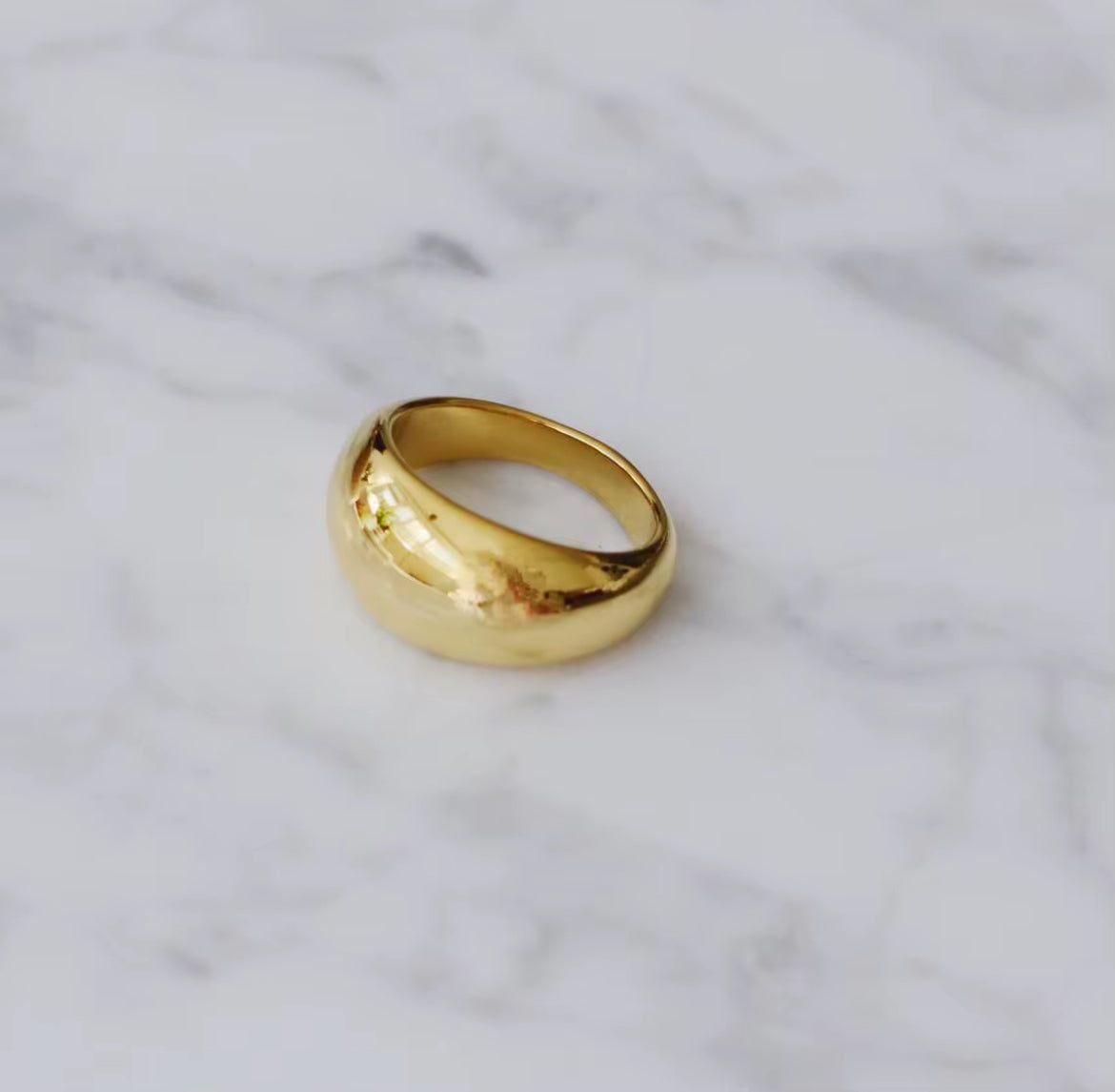 Gold ring on a marble surface