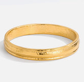 Gold bangle on a white background