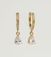 Gold hoop earrings with teardrop-shaped gemstones on a light gray background