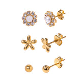Set of gold earrings on a white background