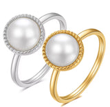 Two pearl rings, one silver and one gold, on a white background
