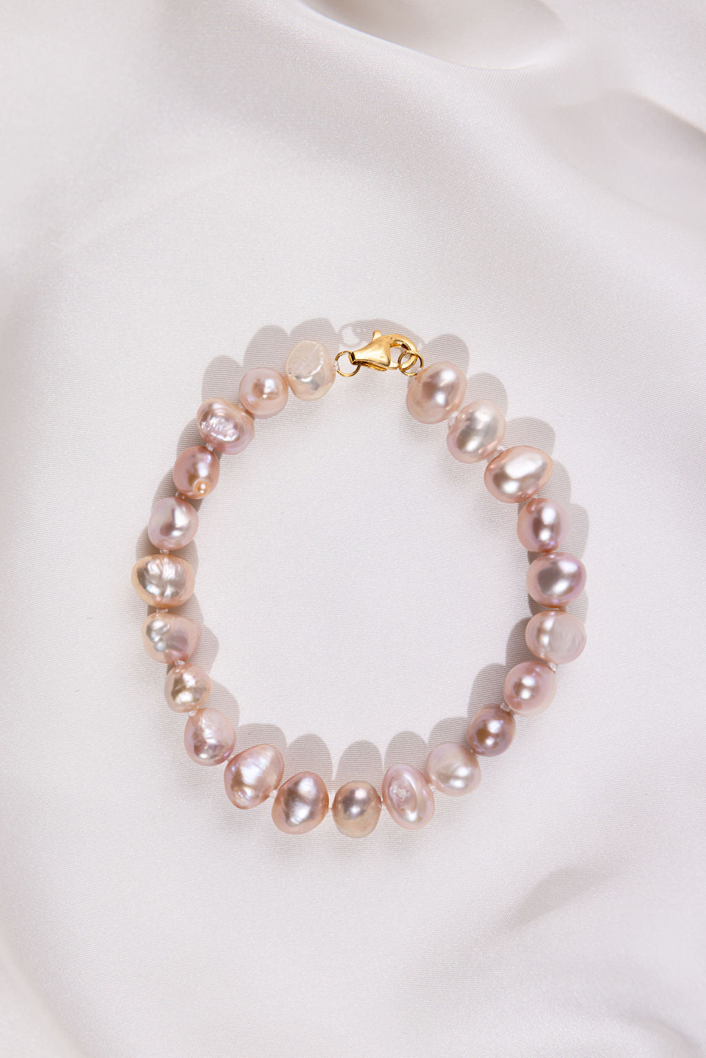 Lavender Pearl bracelet with a gold clasp on a white background