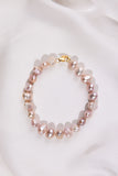 Lavender Pearl bracelet with a gold clasp on a white background