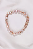 Mixed colour pearl bracelet won a white fabric background