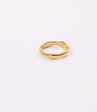 Gold ring on a light beige background