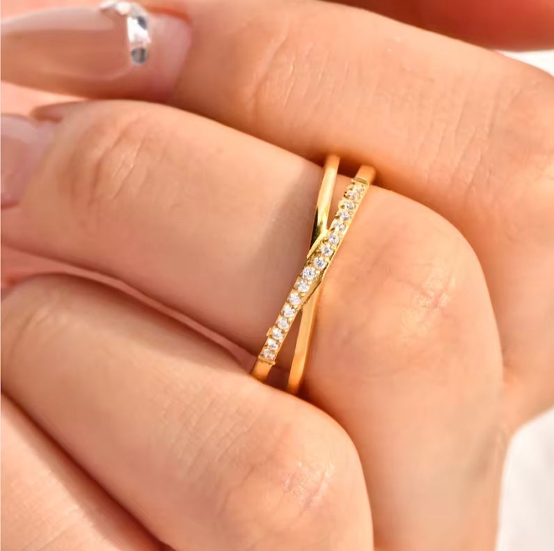 Gold ring with small diamonds on a finger