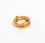 Gold ring with multiple intertwined bands on a white background