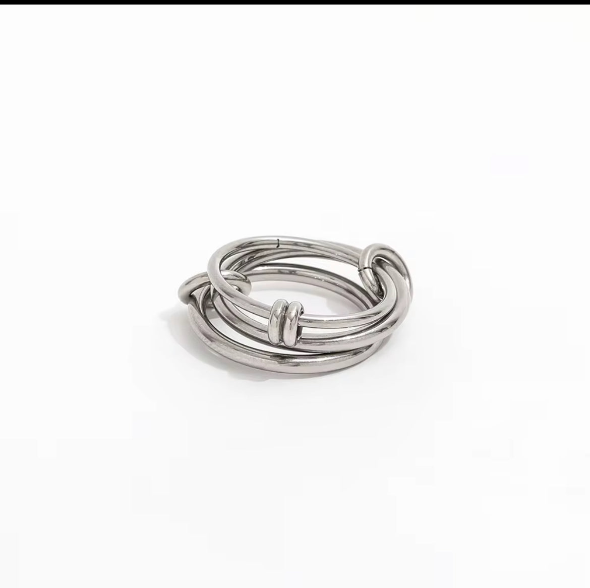 Set of silver rings stacked on a white background