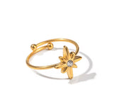 Gold ring with star-shaped design on a white background