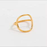 Gold ring on a light gray background