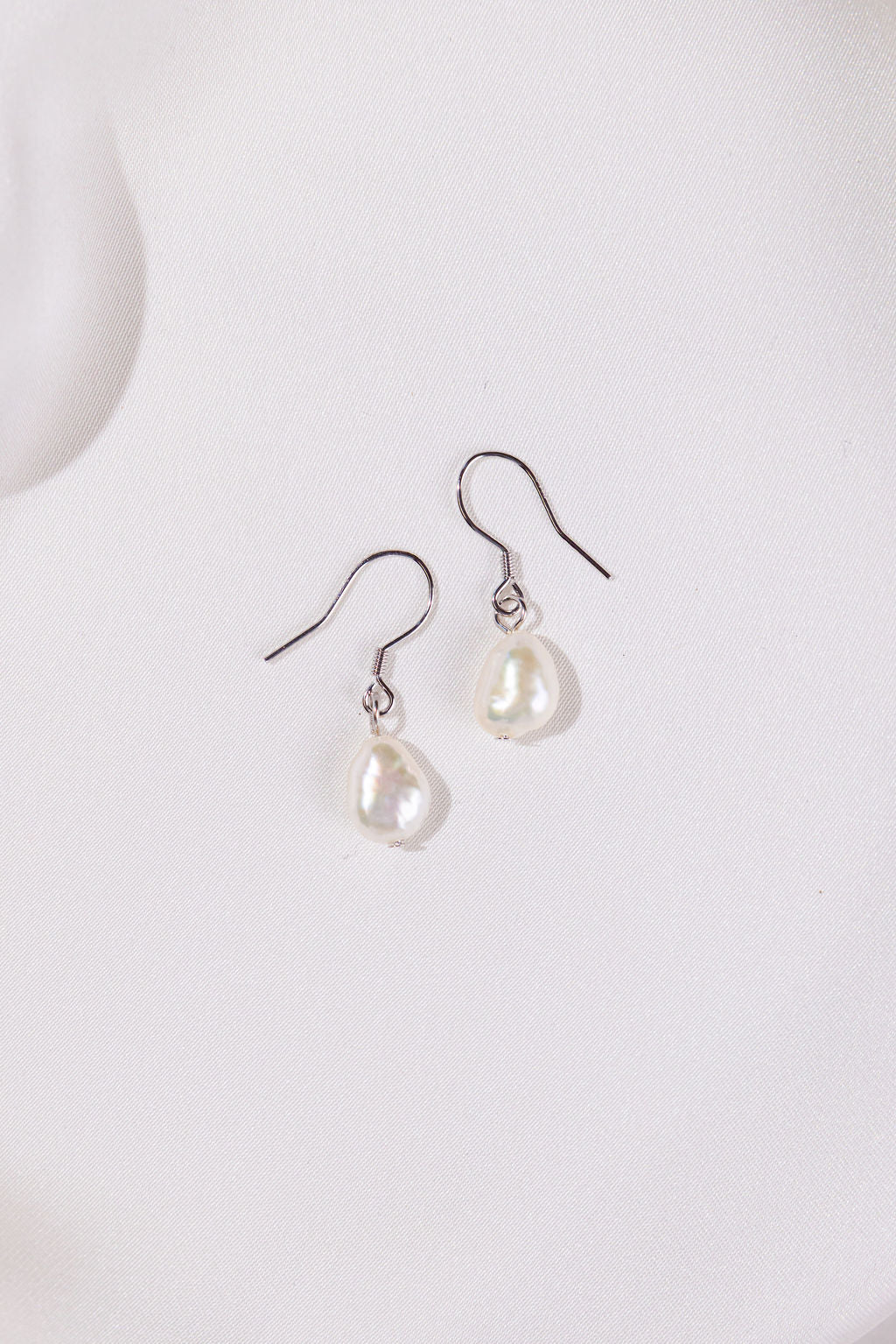 Pair of white pearl earrings on asilver hooks