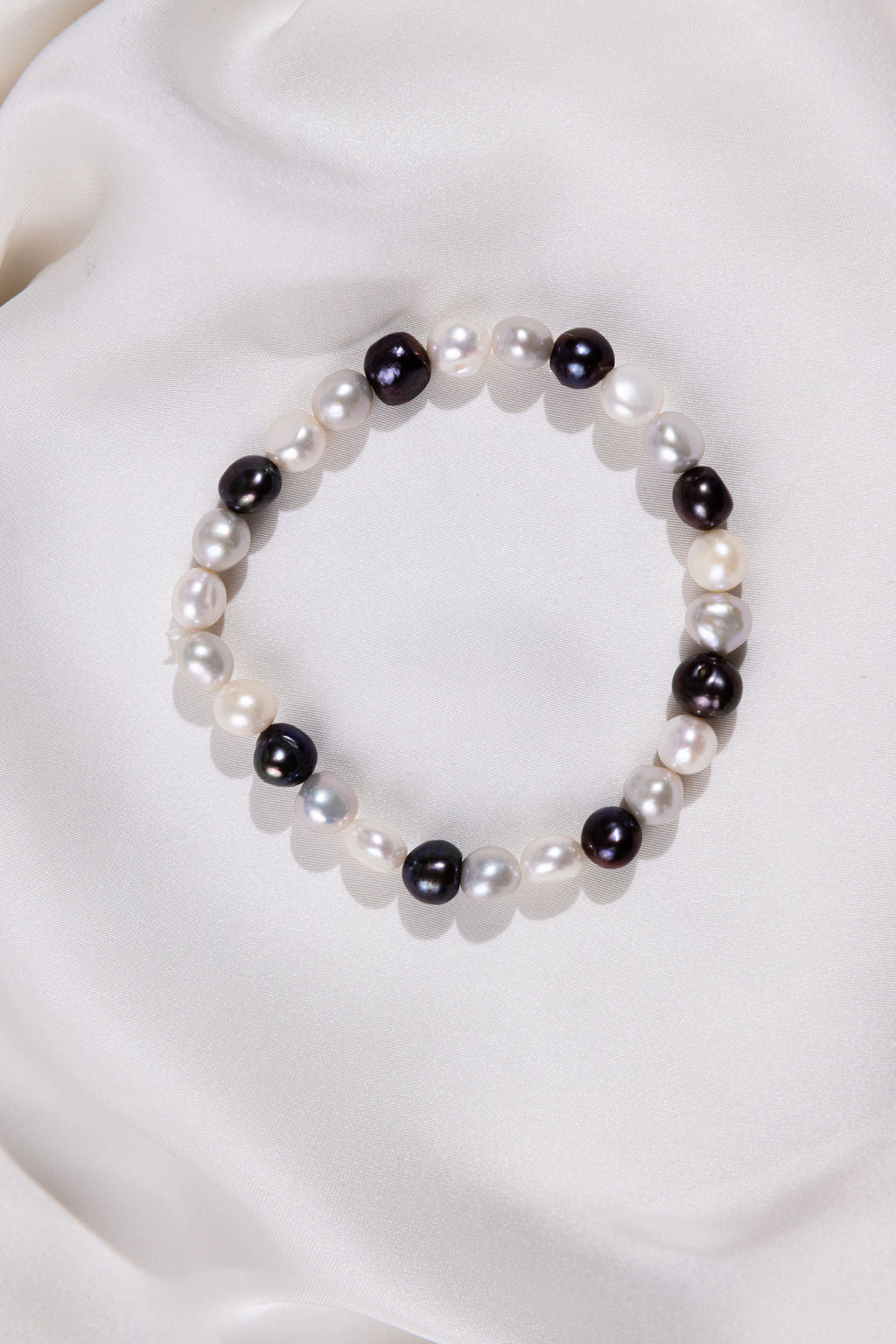 Black and White pearl Bracelet on a silk background