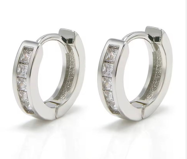 Pair of silver hoop earrings with embedded stones on a white background