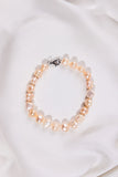 Pink Pearl bracelet on a white fabric background