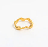 Gold ring with a unique design on a white background