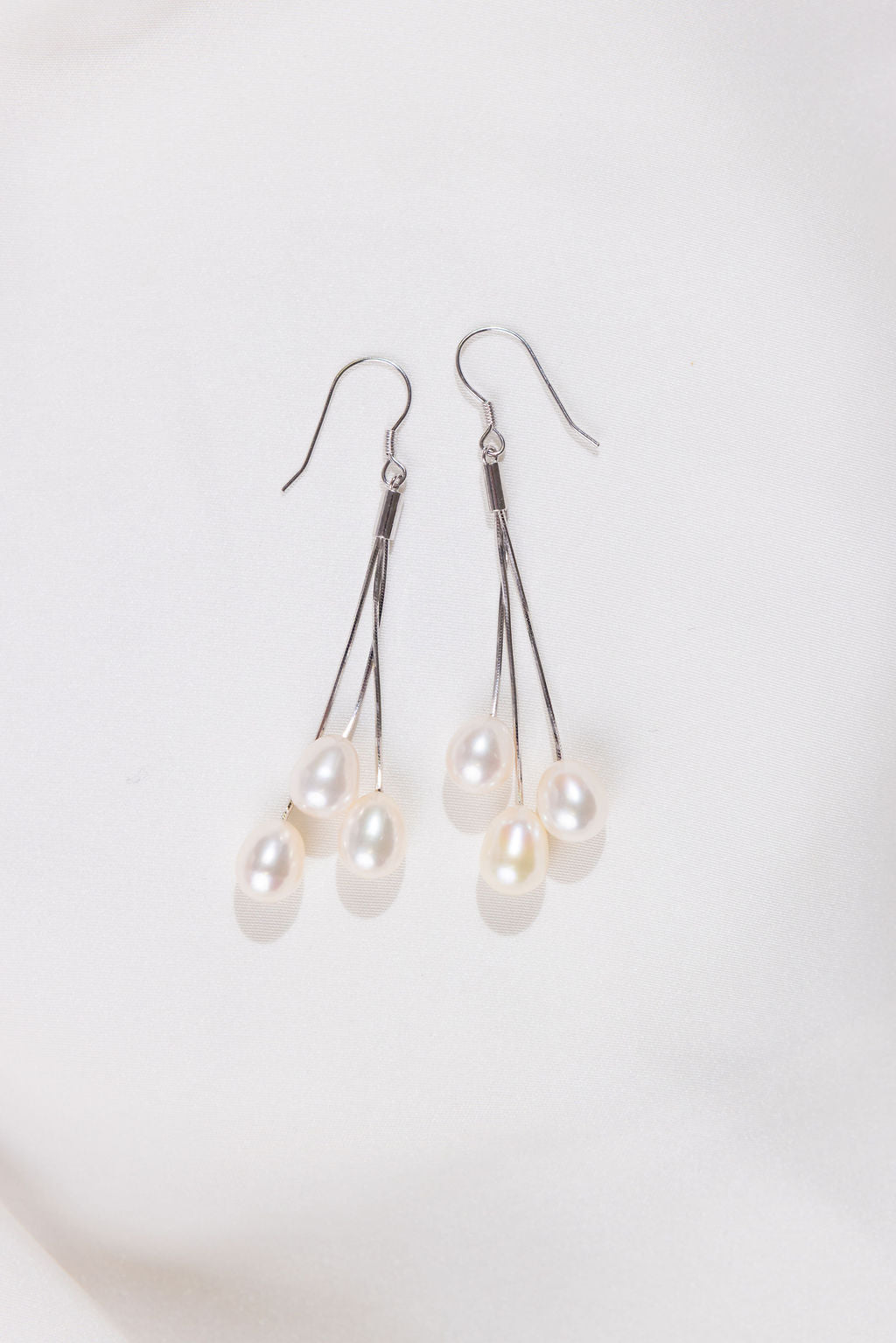 Pearl drop earrings on a white background