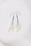 Pearl drop earrings on a white background