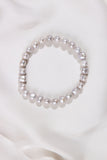 White Pearl bracelet on a white fabric background