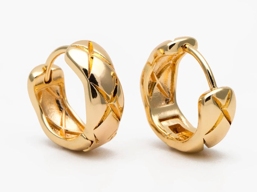 Pair of gold hoop earrings on a white background