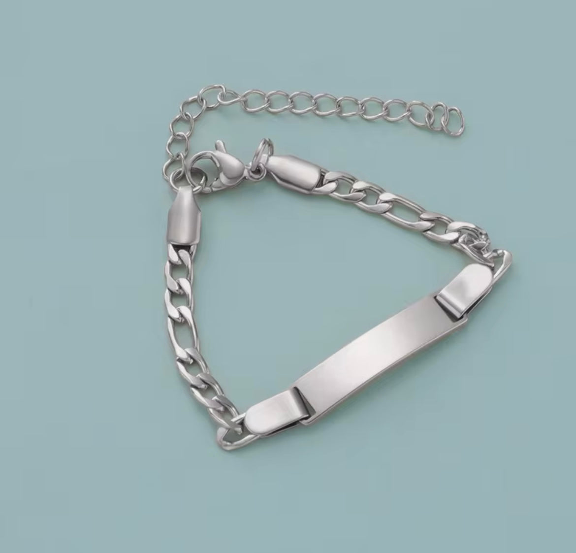 Silver chain bracelet on a light blue background