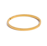 Gold bangle on a white background