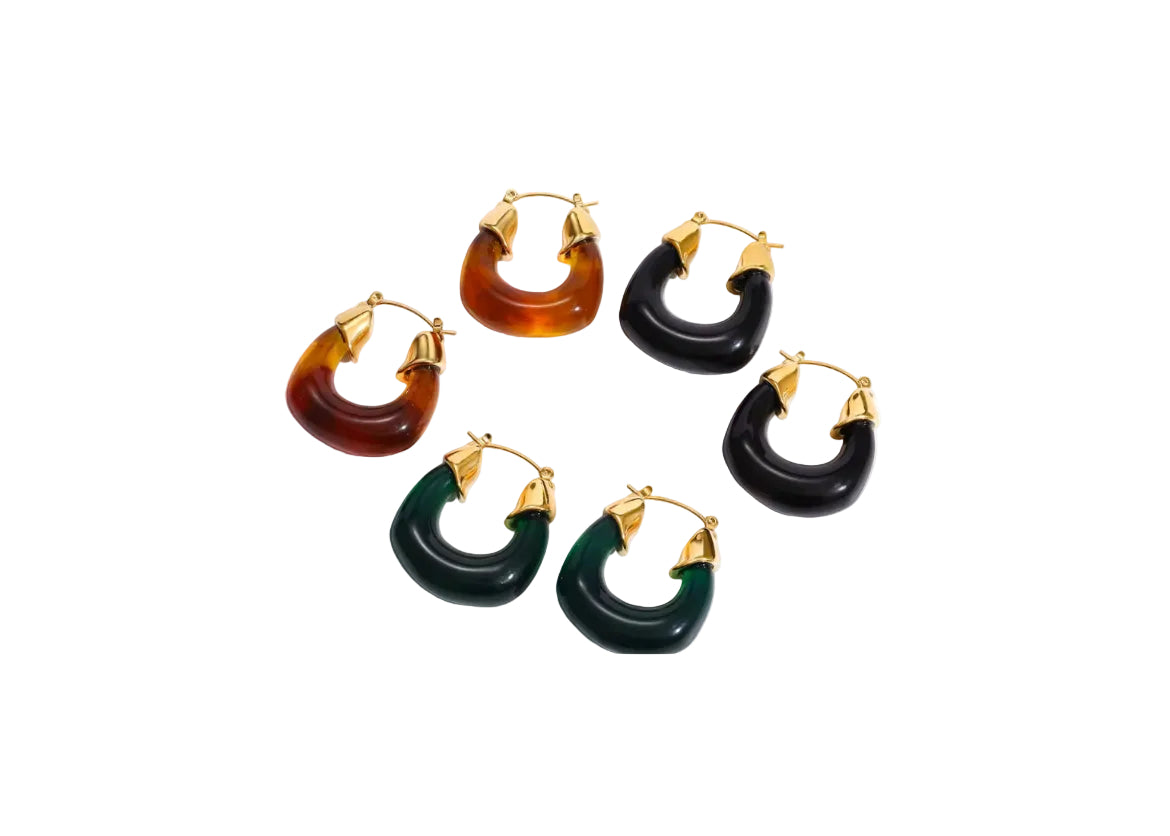 Set of five hoop earrings with gold accents on a white background