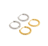 Four gold and silver hoop earrings on a white background