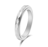 Silver ring with a textured design on a white background