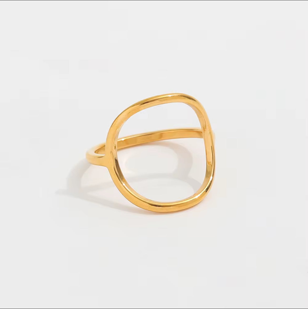 Gold ring on a light gray background