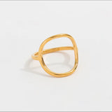 Gold ring on a light gray background
