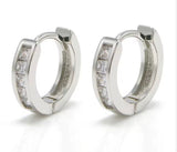 Pair of silver hoop earrings with embedded stones on a white background